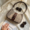 شنطة كروس بودي بطبعة مونوغرام كلاسيكية وتفاصيل جلدية | Monogram Crossbody Bag — Classic Print with Leather Details